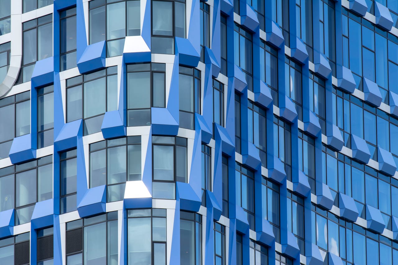 Close-up of a modern blue building facade with geometric patterns in Amsterdam.